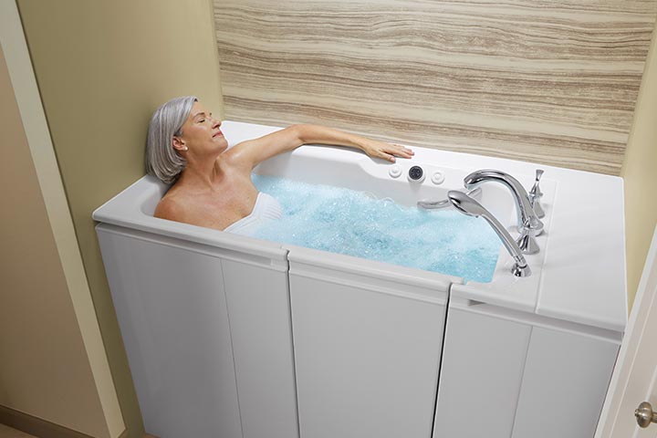 Woman bathing in walk-in tub with whirlpool jets