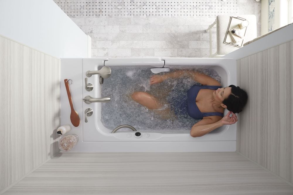 Woman soaks in Walk-In Bath.